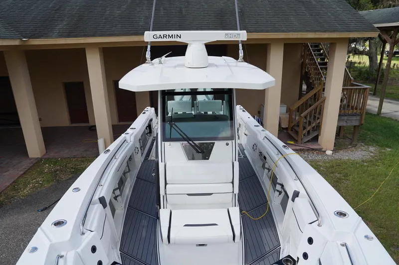  Yacht Photos Pics 2023 Blackfin 302 CC boat with Garmin radar, docked near a building.