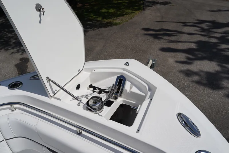  Yacht Photos Pics 2023 Blackfin 302 CC boat anchor compartment with open hatch, showcasing storage and mechanism.