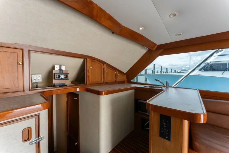 Natural Yacht Photos Pics Interior of 1984 Custom Carolina 41 Ricky Scarborough yacht with wooden cabinetry and modern amenities.