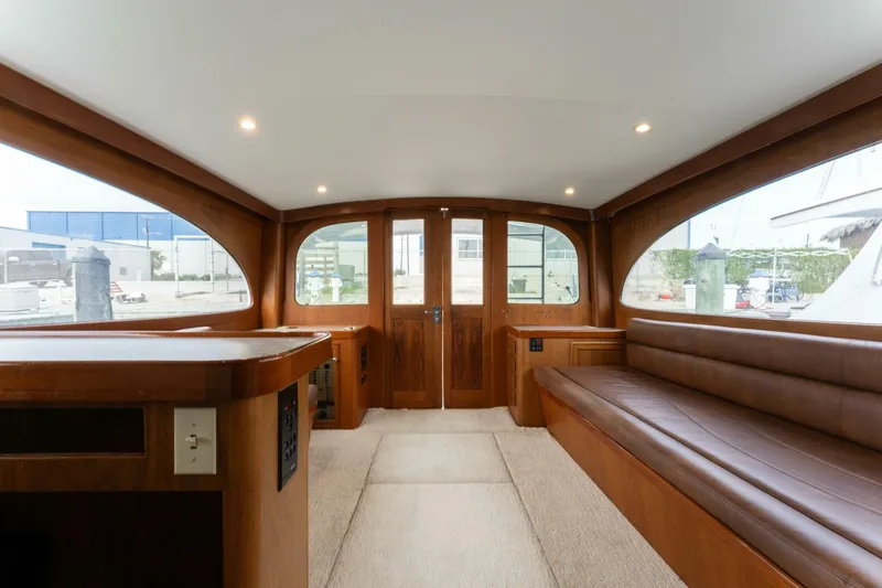 Natural Yacht Photos Pics Interior of 1984 Custom Carolina 41 Ricky Scarborough yacht with wooden finishes and leather seating.