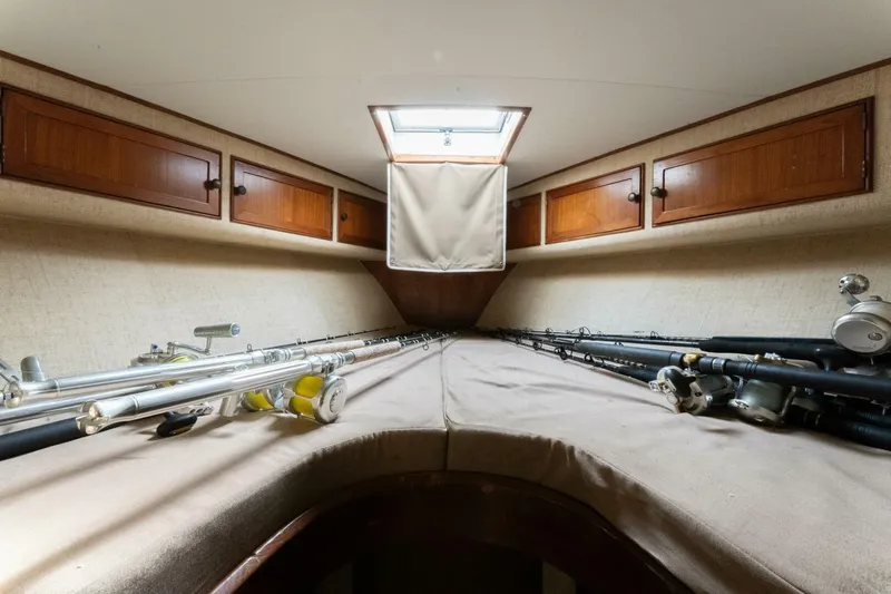Natural Yacht Photos Pics 1984 Custom Carolina 41 Ricky Scarborough cabin with fishing rods and overhead storage.