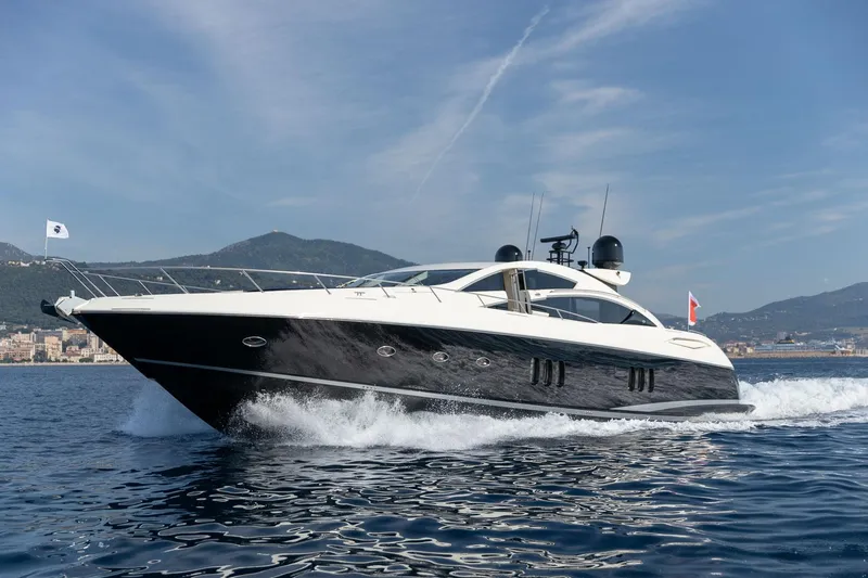 Infinito Yacht Photos Pics 2007 Sunseeker Predator 82 yacht cruising on open water with scenic mountain backdrop.