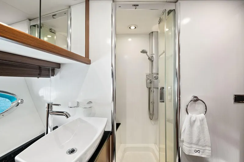 Infinito Yacht Photos Pics Luxurious bathroom in 2007 Sunseeker Predator 82 yacht, featuring modern shower and sleek sink design.