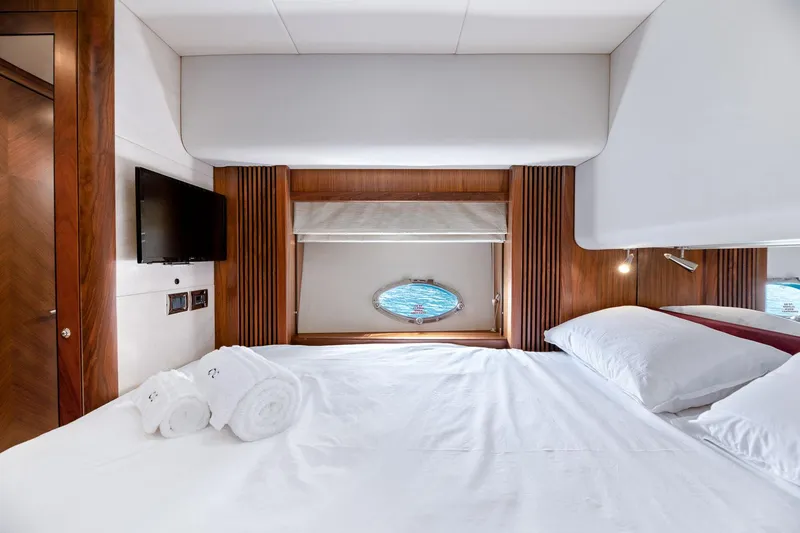 Infinito Yacht Photos Pics Luxurious bedroom interior of 2007 Sunseeker Predator 82 yacht with porthole view.