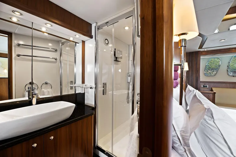 Infinito Yacht Photos Pics Luxurious bathroom and bedroom on 2007 Sunseeker Predator 82 yacht, featuring modern amenities.