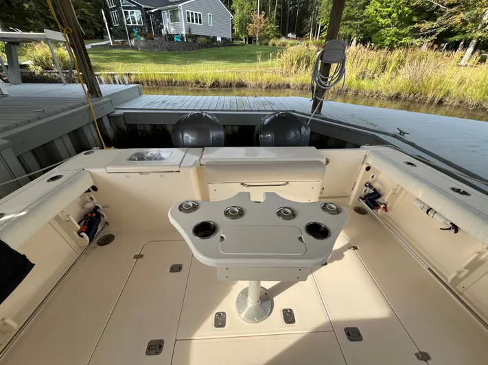  Yacht Photos Pics 2010 Pursuit OS 345 Offshore boat interior with fishing rod holders and seating.