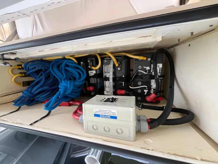  Yacht Photos Pics 2010 Pursuit OS 345 Offshore boat battery compartment with cables and electrical components.