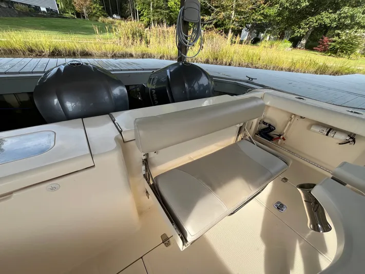  Yacht Photos Pics 2010 Pursuit OS 345 Offshore boat interior with seating and dual outboard motors.