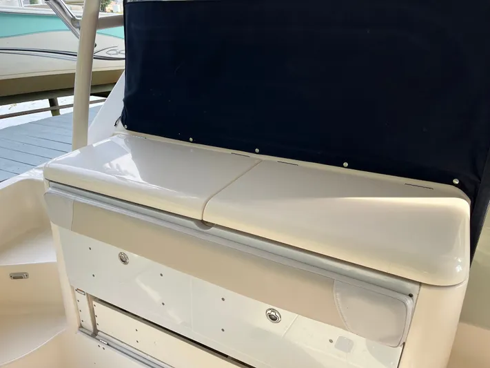  Yacht Photos Pics 2010 Pursuit OS 345 Offshore boat interior with storage compartment and seating.