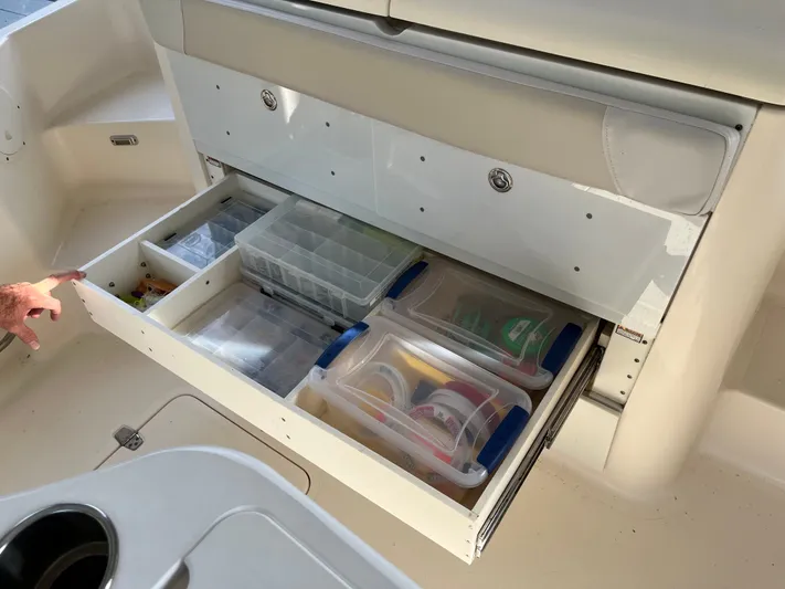  Yacht Photos Pics 2010 Pursuit OS 345 Offshore boat storage drawer with organized fishing gear and tackle boxes.