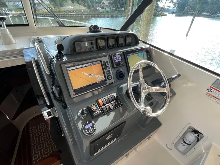  Yacht Photos Pics 2010 Pursuit OS 345 Offshore boat helm with navigation screens and controls.