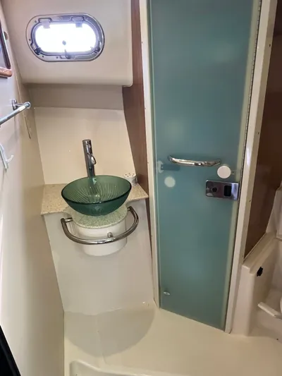  Yacht Photos Pics 2010 Pursuit OS 345 Offshore bathroom with glass sink and frosted door.