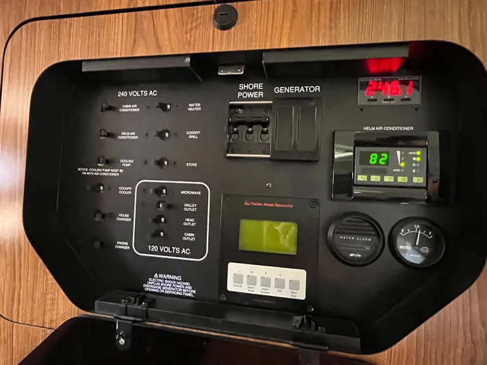  Yacht Photos Pics Control panel of a 2010 Pursuit OS 345 Offshore boat, displaying voltage and air conditioning settings.