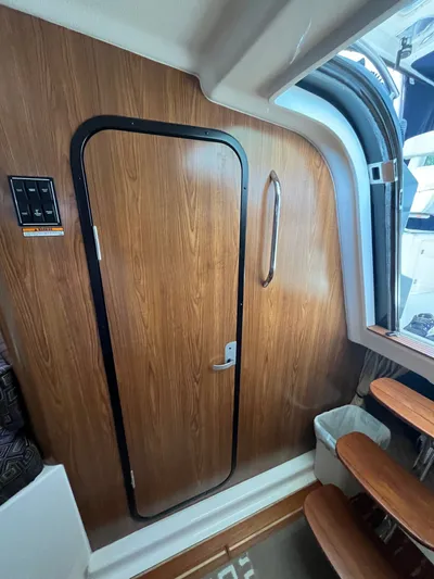  Yacht Photos Pics Interior of 2010 Pursuit OS 345 Offshore boat with wooden door and steps.