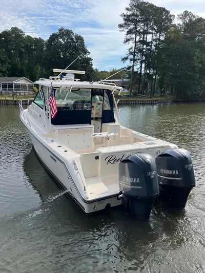  Yacht Photos Pics 2010 Pursuit OS 345 Offshore boat with twin Yamaha 350 engines on a calm river.