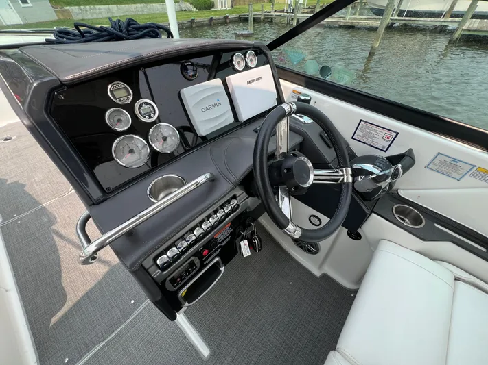 4th Quarter Yacht Photos Pics 2016 Formula 310 Bowrider dashboard with Garmin navigation, steering wheel, and control panel.