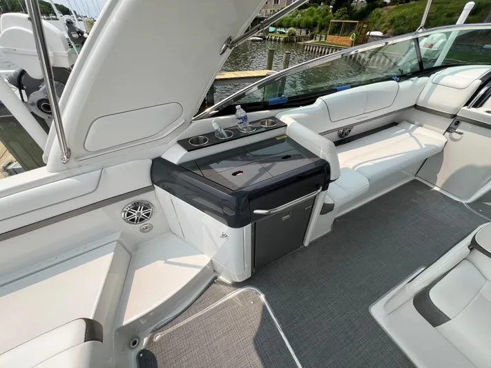 4th Quarter Yacht Photos Pics 2016 Formula 310 Bowrider interior with seating, mini fridge, and cup holders.