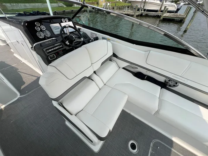 4th Quarter Yacht Photos Pics 2016 Formula 310 Bowrider interior with white seating and modern dashboard controls.