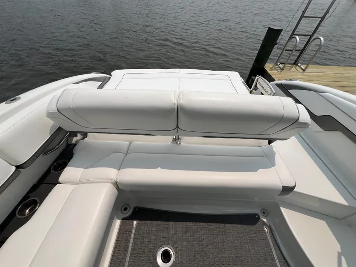 4th Quarter Yacht Photos Pics 2016 Formula 310 Bowrider boat interior with white seating, docked by the water.