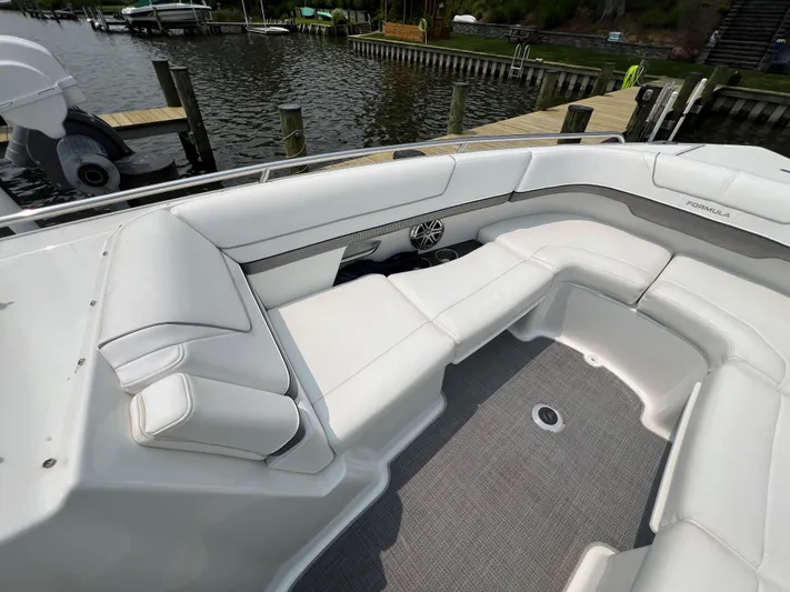 4th Quarter Yacht Photos Pics 2016 Formula 310 Bowrider with white seating, docked by a wooden pier.