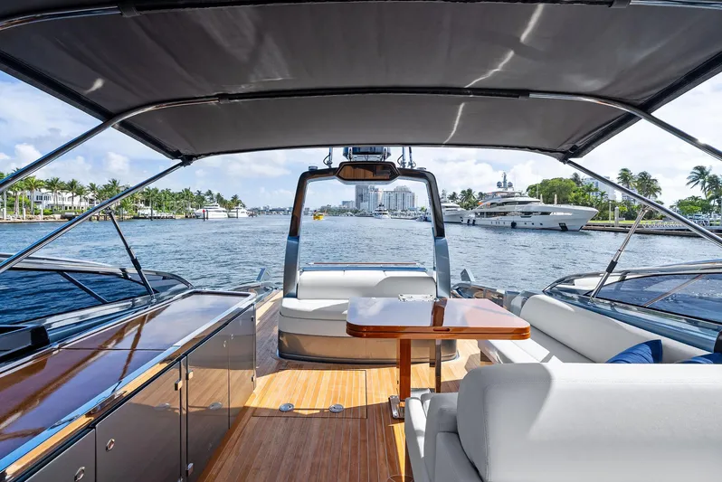 Phantom Yacht Photos Pics 2019 Riva 56 Rivale yacht interior with elegant seating and table, overlooking marina.