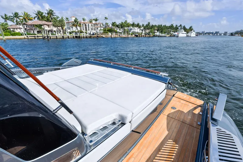 Phantom Yacht Photos Pics 2019 Riva 56 Rivale yacht with sun deck, cruising near luxury waterfront homes.