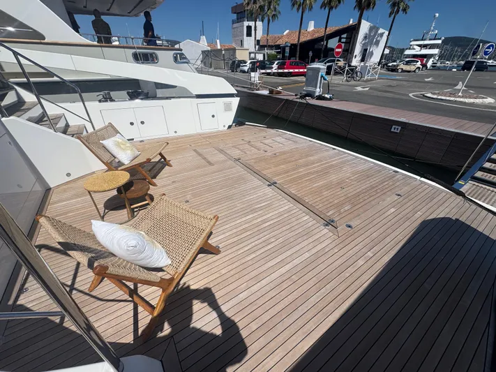  Yacht Photos Pics Luxury Sanlorenzo SX88 yacht deck with chairs, table, and marina view, 2018 model.