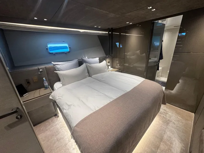 Yacht Photos Pics Luxurious bedroom interior of 2018 Sanlorenzo SX88 yacht with modern design and ambient lighting.