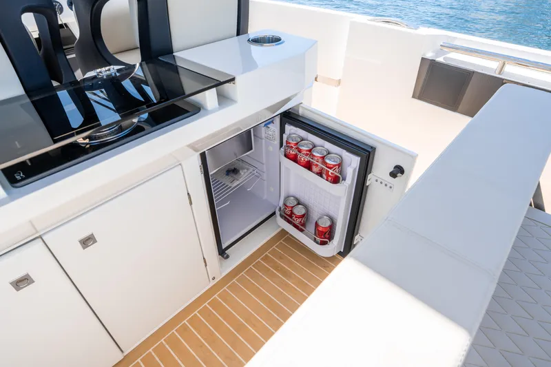  Yacht Photos Pics Mini fridge on De Antonio Yachts D32 OPEN 2025, stocked with drinks, open on deck.