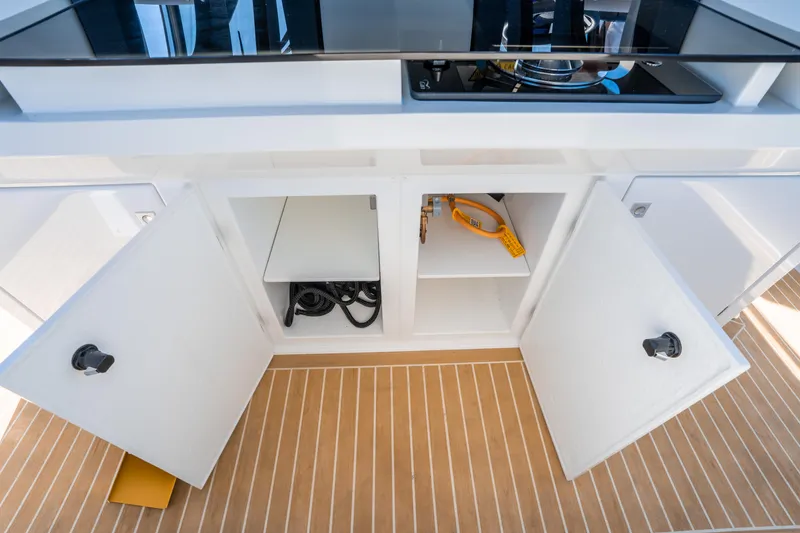  Yacht Photos Pics 2025 De Antonio Yachts D32 OPEN kitchen area with open cabinets and modern appliances.
