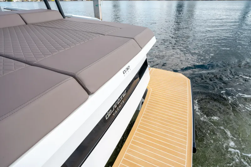  Yacht Photos Pics 2025 De Antonio Yachts D32 OPEN with cushioned deck and swim platform on water.
