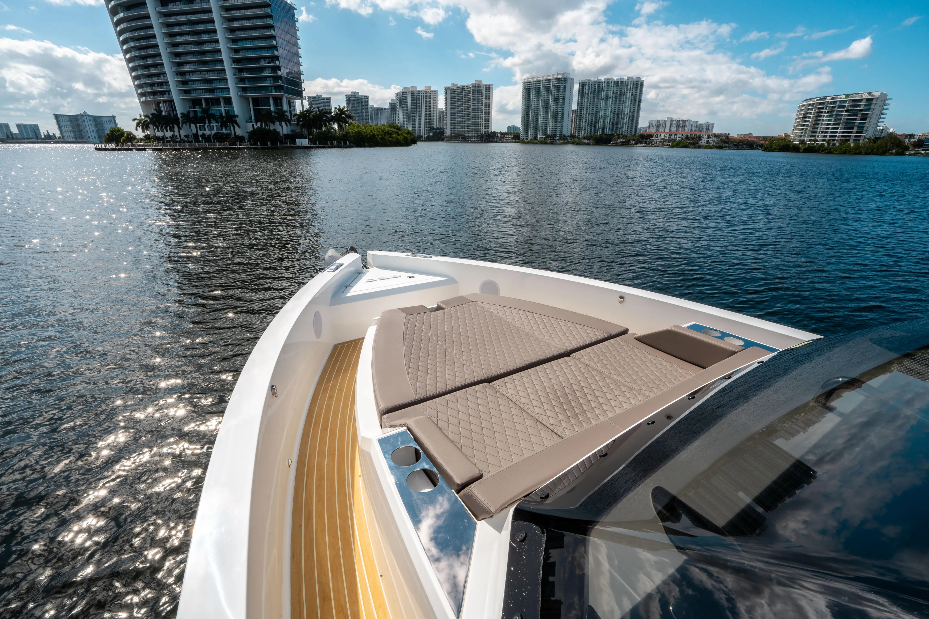  Yacht Photos Pics 2025 De Antonio Yachts D32 OPEN on water, city skyline in background.