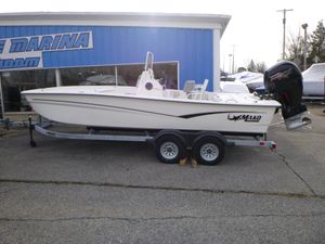 2023 Mako Pro Skiff 19 CC boat on trailer outside marina.