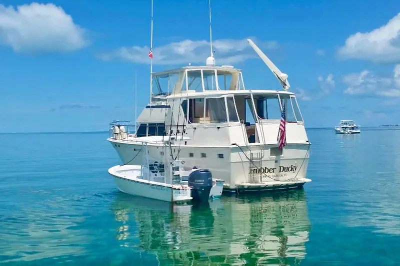 Rubber Ducky Yacht Photos Pics 1981 Hatteras 48 Motor Yacht on clear blue water under a sunny sky.