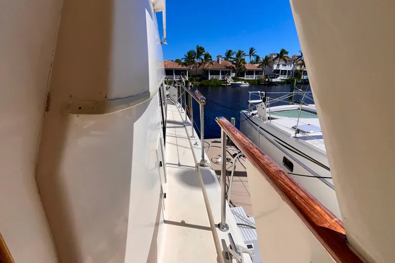 Rubber Ducky Yacht Photos Pics 1981 Hatteras 48 Motor Yacht docked, featuring side deck and marina view.