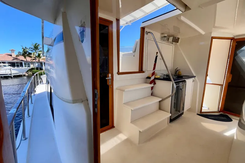 Rubber Ducky Yacht Photos Pics 1981 Hatteras 48 Motor Yacht interior with steps, kitchenette, and outdoor view.