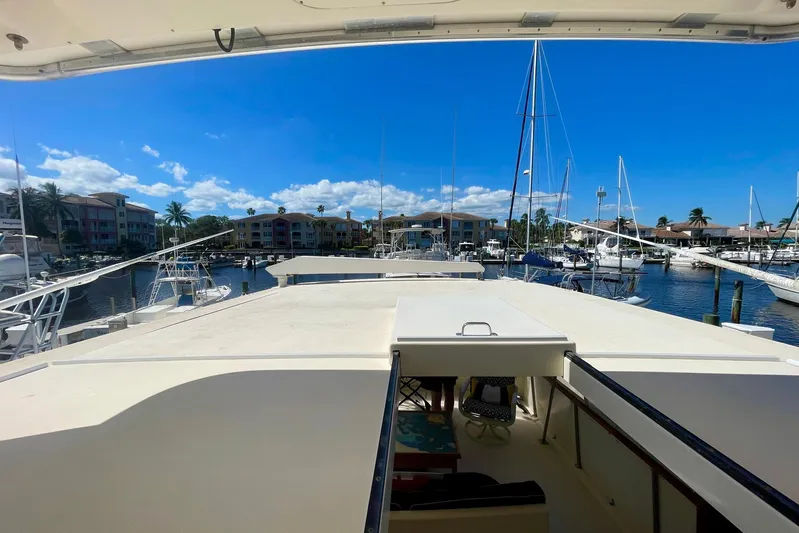 Rubber Ducky Yacht Photos Pics 1981 Hatteras 48 Motor Yacht docked in a sunny marina with clear blue skies.