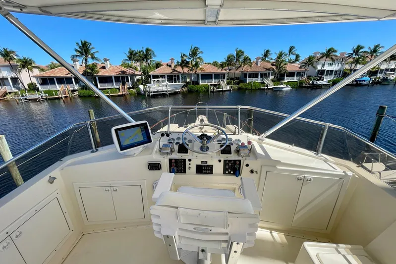 Rubber Ducky Yacht Photos Pics 1981 Hatteras 48 Motor Yacht helm with waterfront view and palm trees.