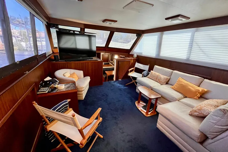 Rubber Ducky Yacht Photos Pics Interior of 1981 Hatteras 48 Motor Yacht with cozy seating and large windows.