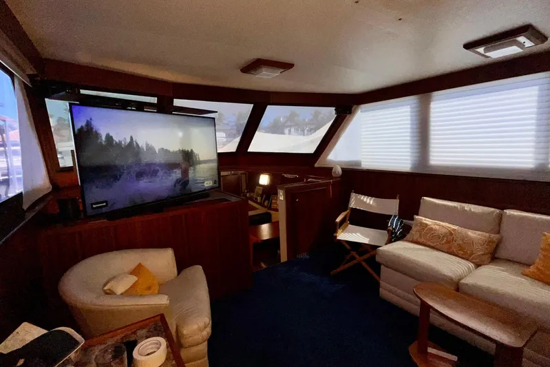 Rubber Ducky Yacht Photos Pics Interior of 1981 Hatteras 48 Motor Yacht with cozy seating and large TV.