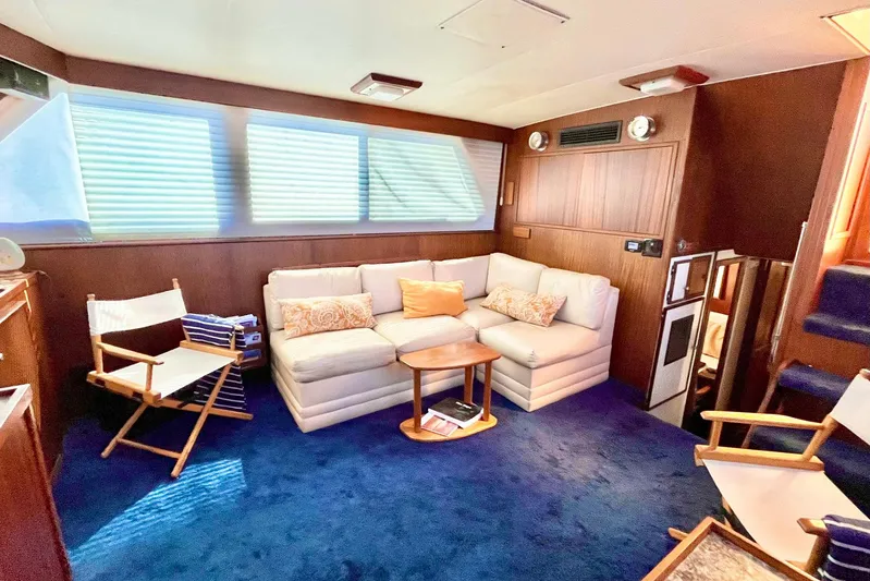 Rubber Ducky Yacht Photos Pics Interior of 1981 Hatteras 48 Motor Yacht with cozy seating and nautical decor.