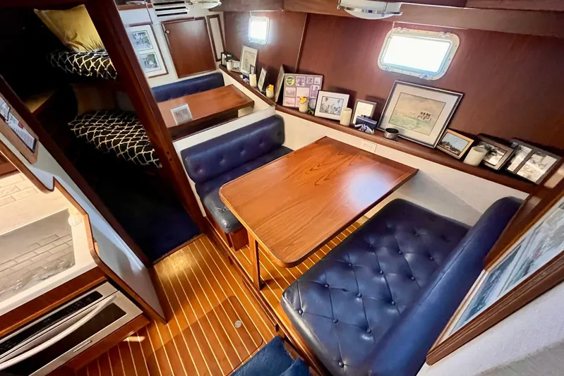 Rubber Ducky Yacht Photos Pics Interior of 1981 Hatteras 48 Motor Yacht with cozy dining area and wood accents.