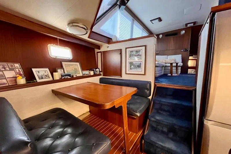 Rubber Ducky Yacht Photos Pics Interior of 1981 Hatteras 48 Motor Yacht with dining area and cozy seating.