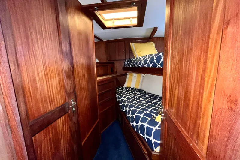 Rubber Ducky Yacht Photos Pics Interior of 1981 Hatteras 48 Motor Yacht with wooden bunk beds and nautical decor.