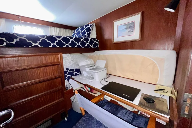 Rubber Ducky Yacht Photos Pics Interior of 1981 Hatteras 48 Motor Yacht with desk, laptop, and bunk bed.