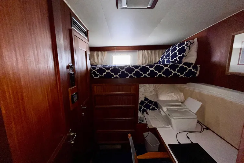 Rubber Ducky Yacht Photos Pics 1981 Hatteras 48 Motor Yacht interior cabin with bunk bed and wooden cabinetry.