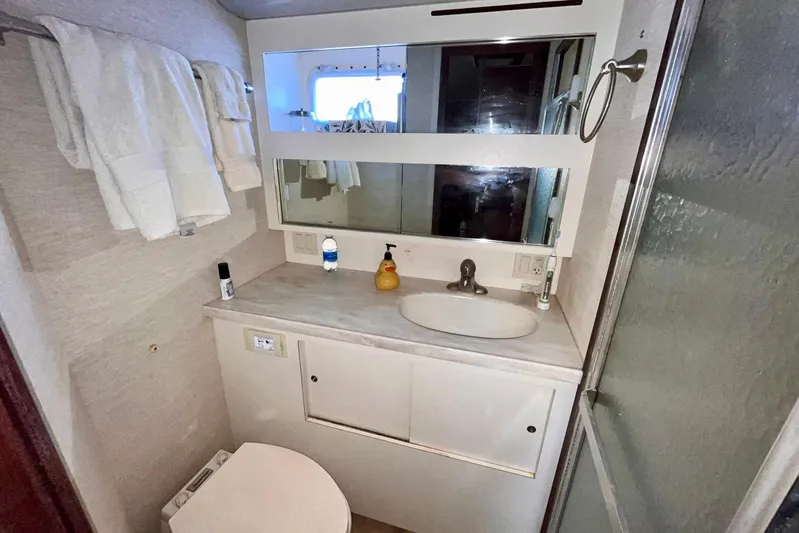 Rubber Ducky Yacht Photos Pics Bathroom interior of 1981 Hatteras 48 Motor Yacht with sink, mirror, and shower.
