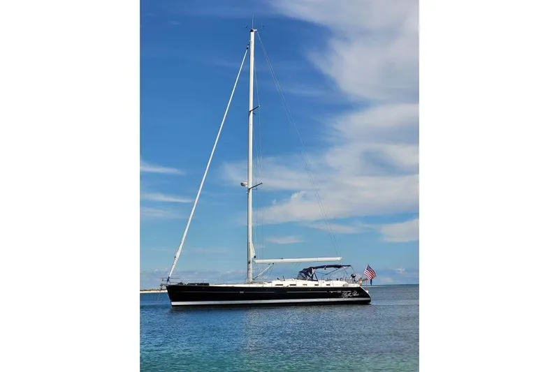  Yacht Photos Pics 2007 Beneteau Oceanis 523 sailboat on calm water under a clear blue sky.