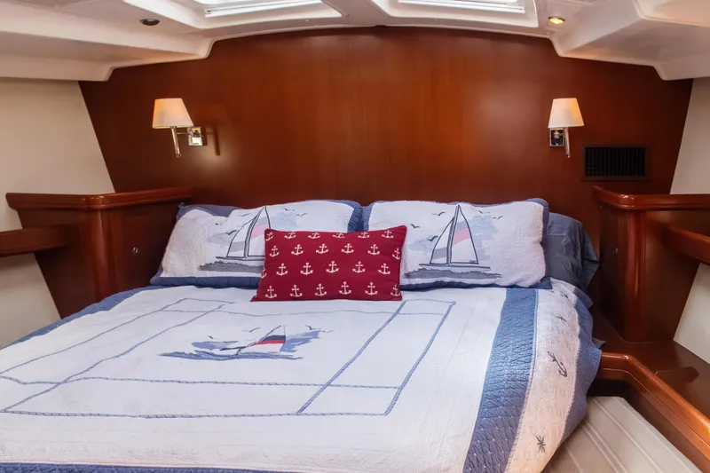  Yacht Photos Pics Luxurious cabin interior of 2007 Beneteau Oceanis 523 yacht with nautical-themed bedding.
