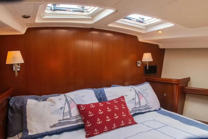  Yacht Photos Pics Luxurious cabin interior of 2007 Beneteau Oceanis 523 yacht with nautical-themed bedding.
